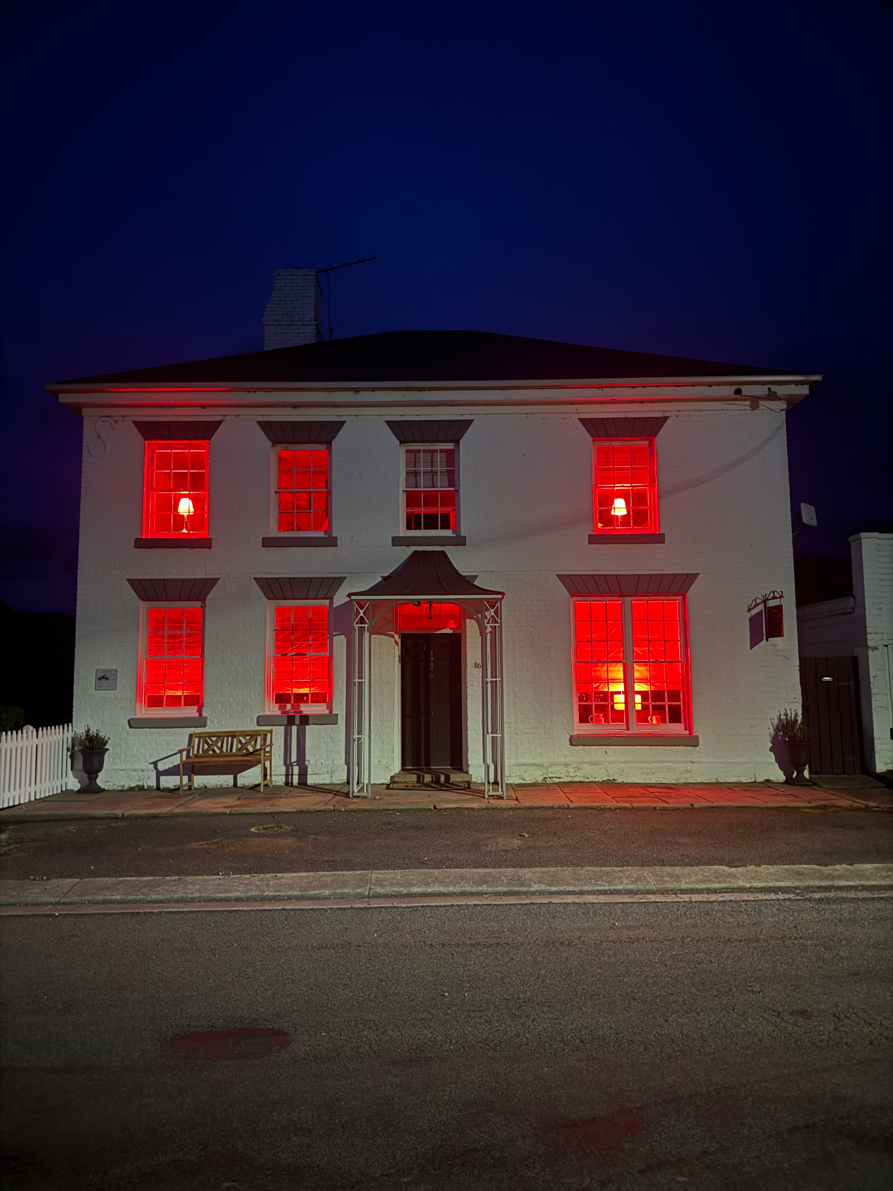 House with red lights in the windows.